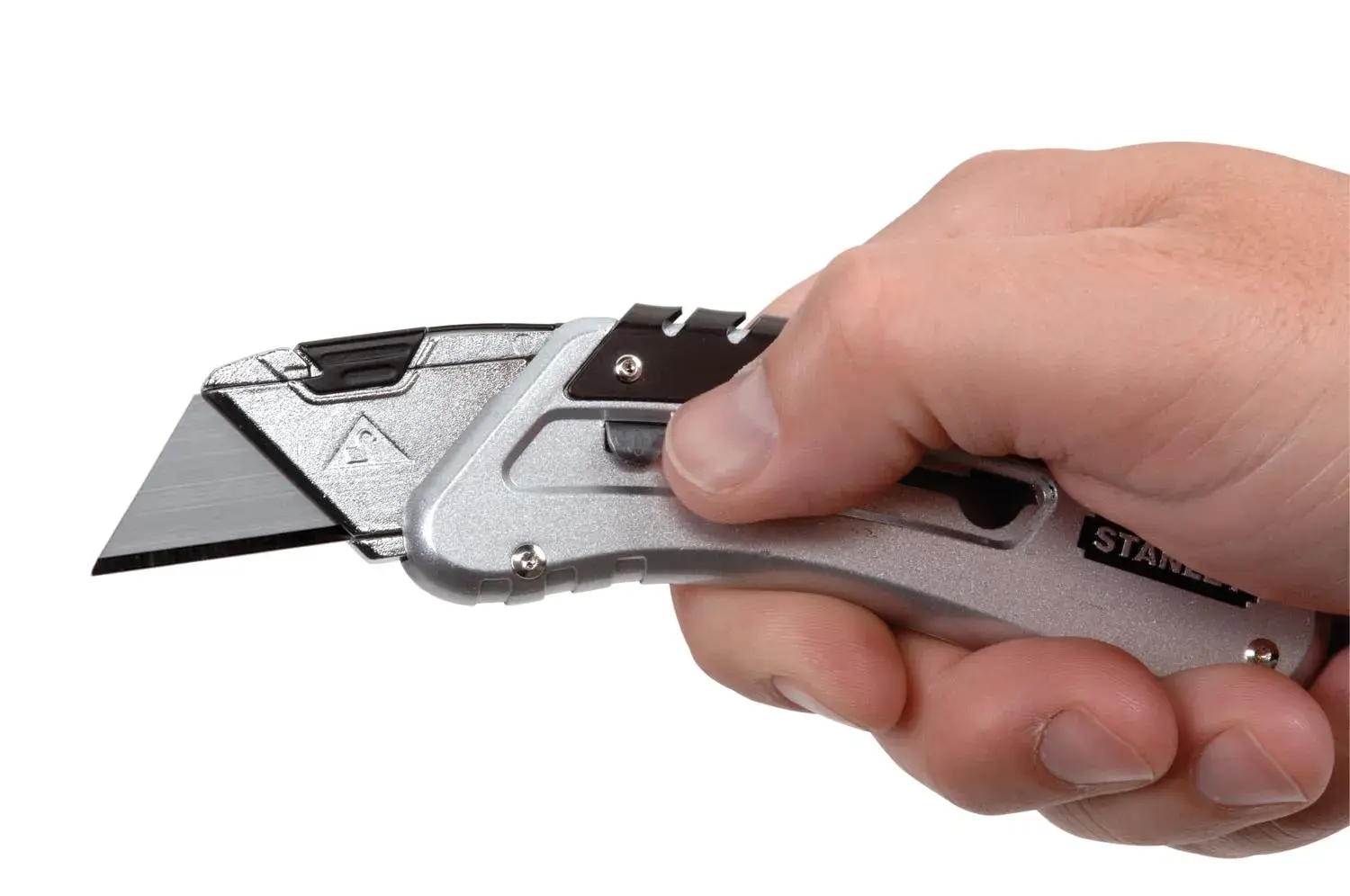 Photo of STANLEY 0-10-810 utility knife with silver body, held in a hand, side angle on white background.