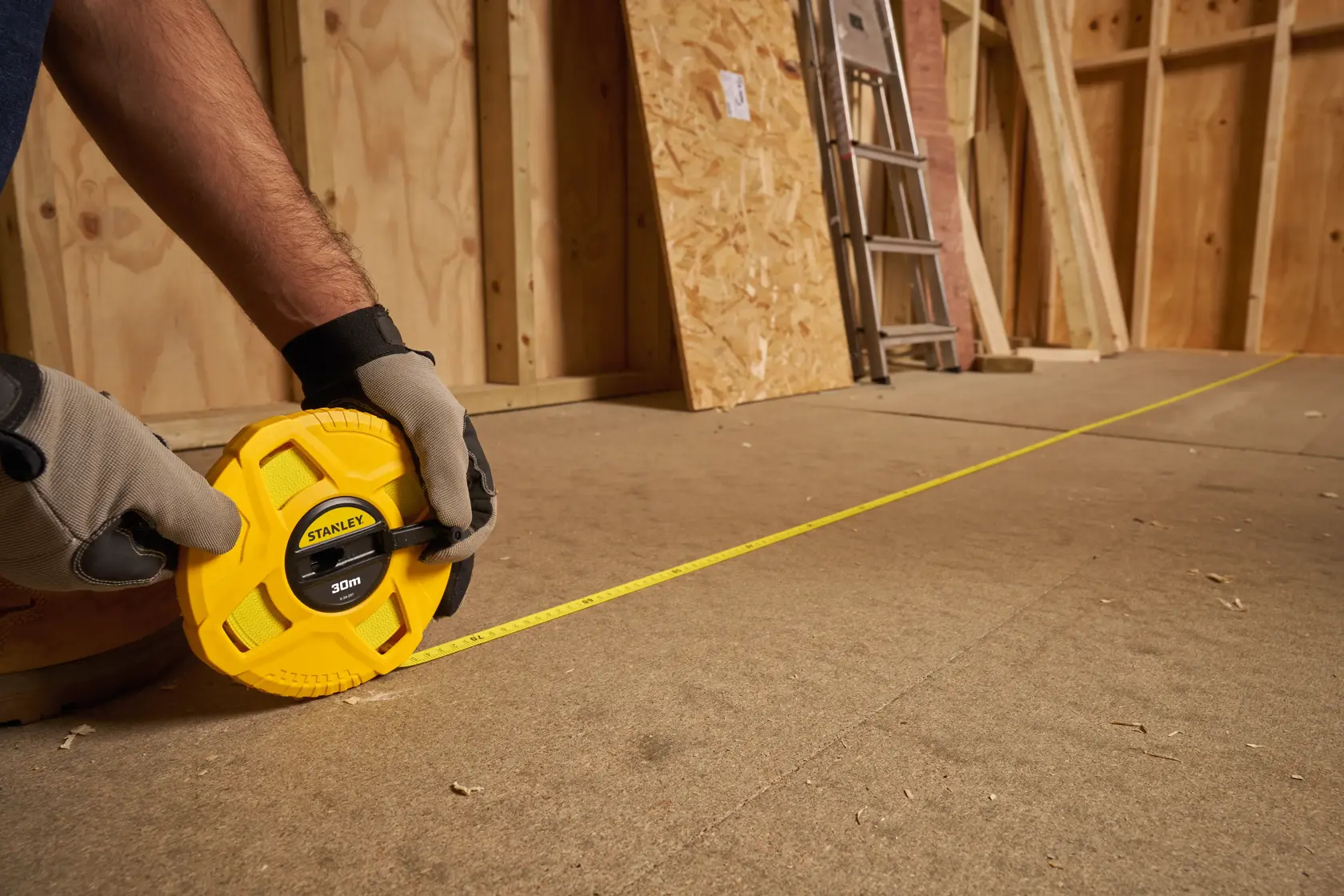 Photo of STANLEY 0-34-297 measuring tape being used on a construction site floor.