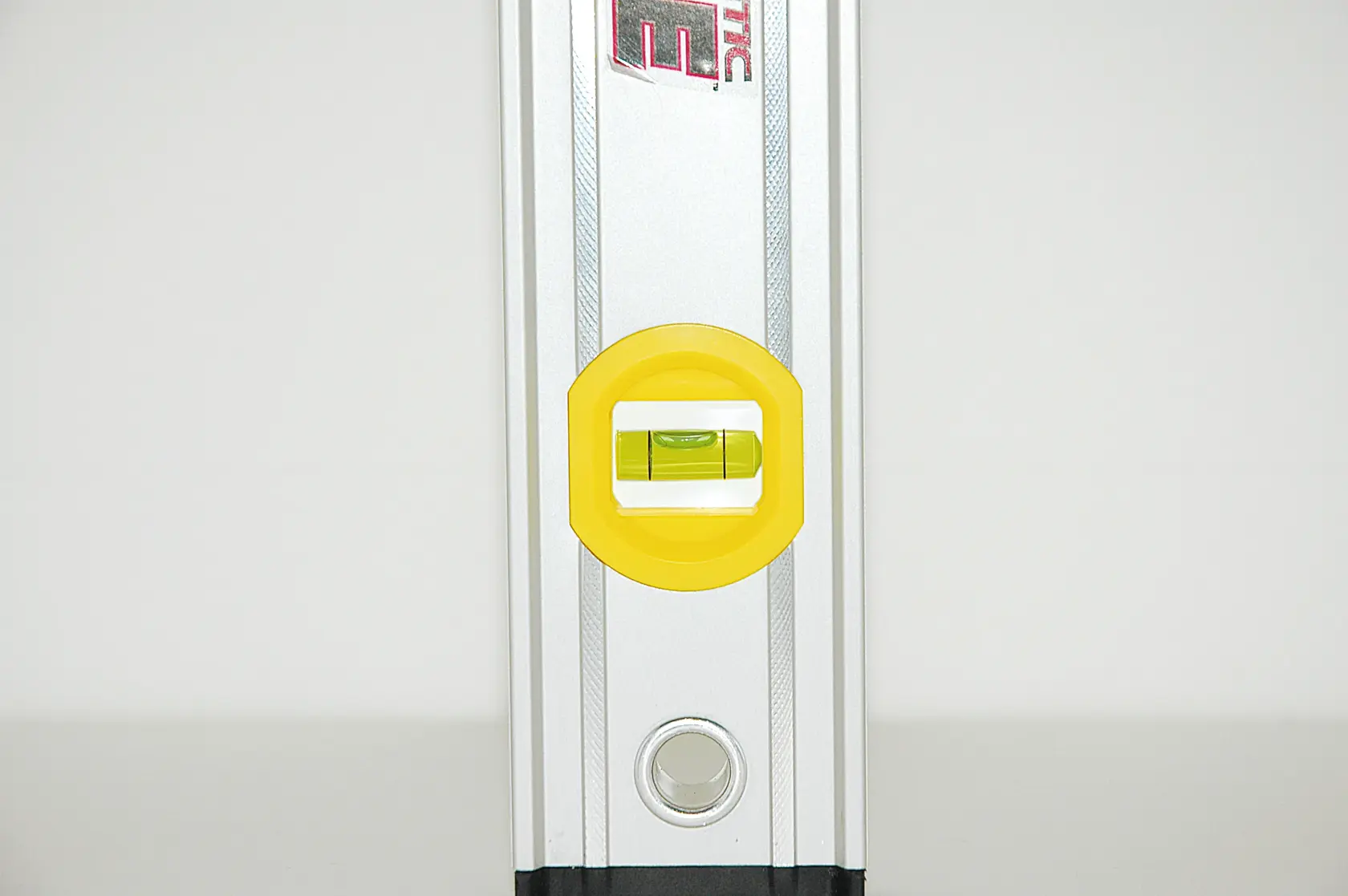 STANLEY 0-43-625 spirit level front angle, silver body, yellow vial housing, photography.