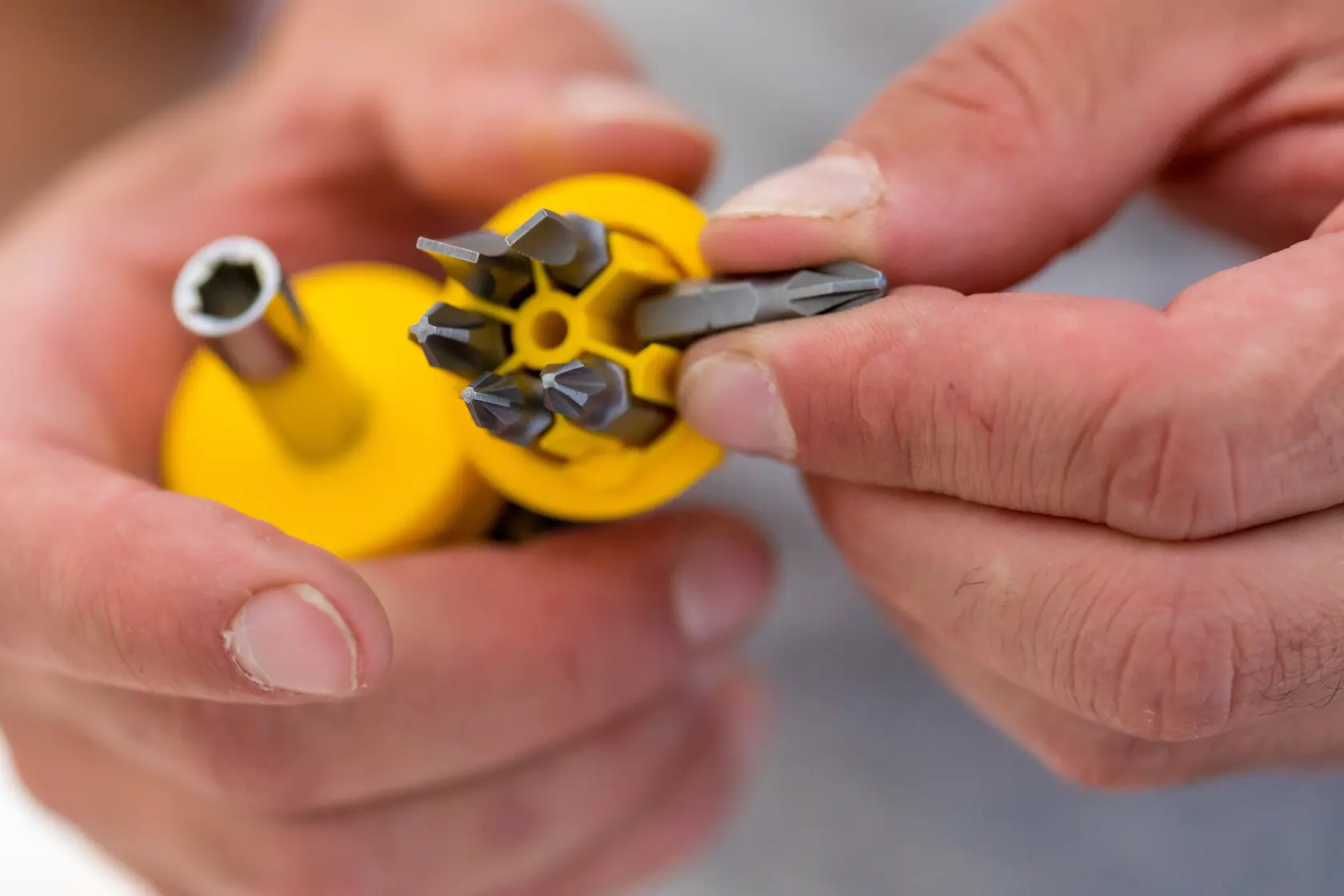 STANLEY 0-66-357 screwdriver set with yellow handle and multiple interchangeable bits shown in hand, close-up.