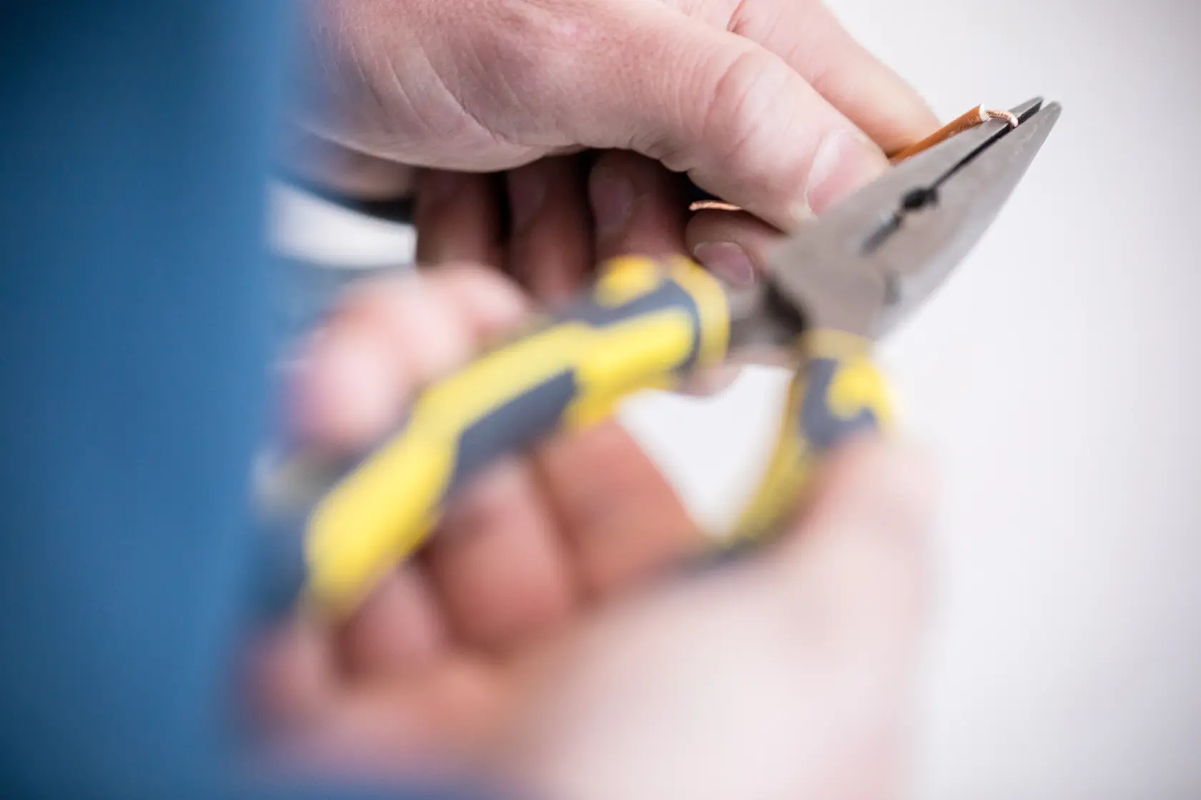 STANLEY 0-89-870 pliers with yellow and black handles in use, close-up photography.