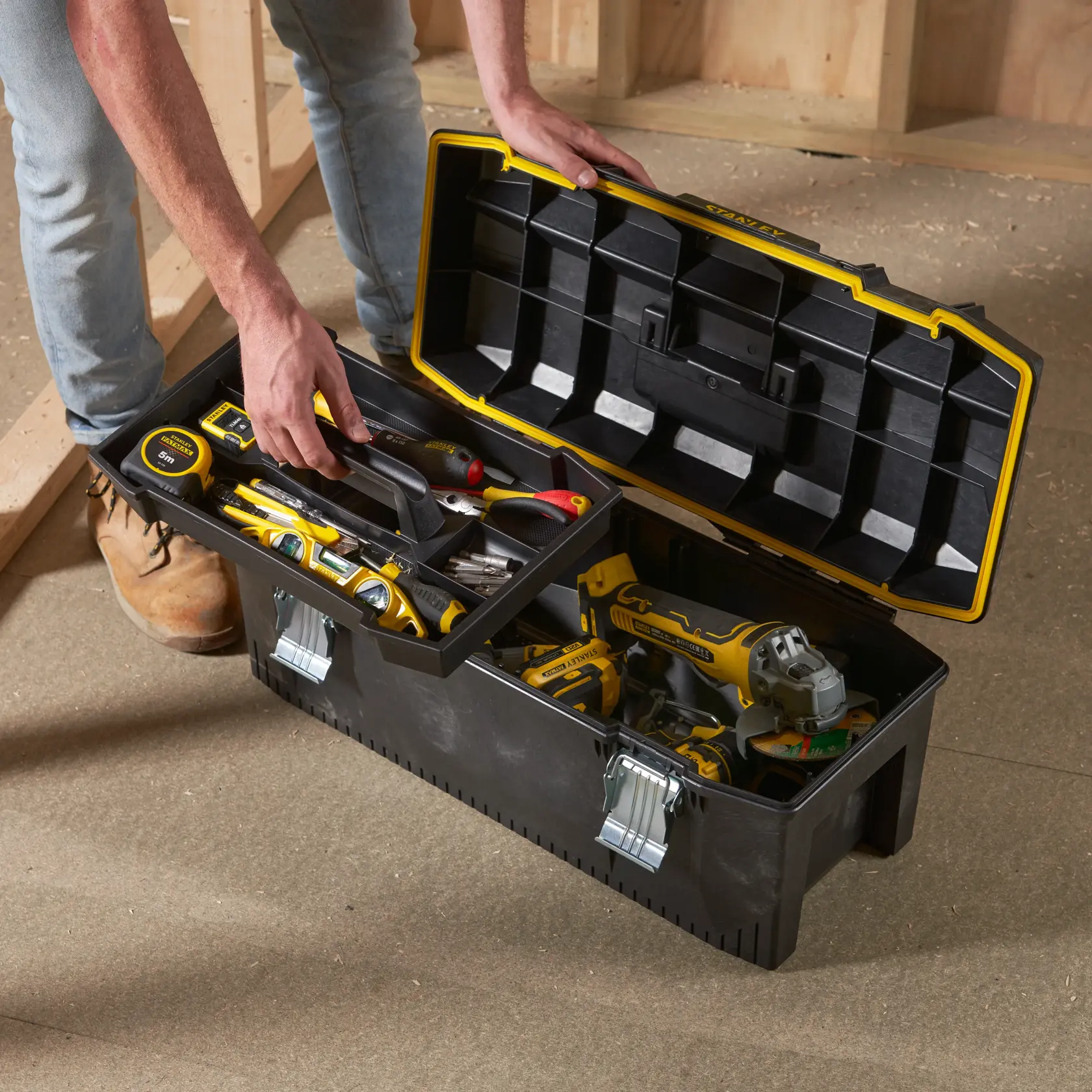 STANLEY 1-93-935 toolbox with yellow trim and metal latches, open, filled with hand tools and drill.