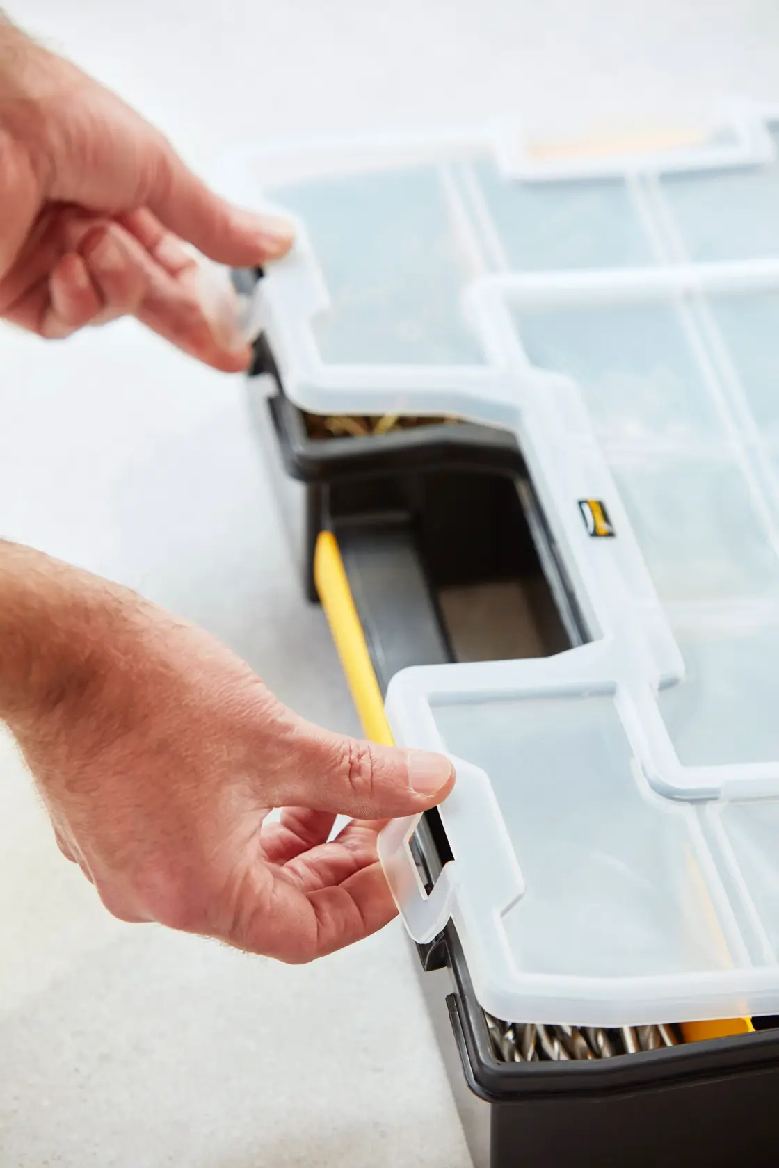 Photo of STANLEY 1-94-745 organizer box with clear lid being opened, black and yellow plastic compartments.