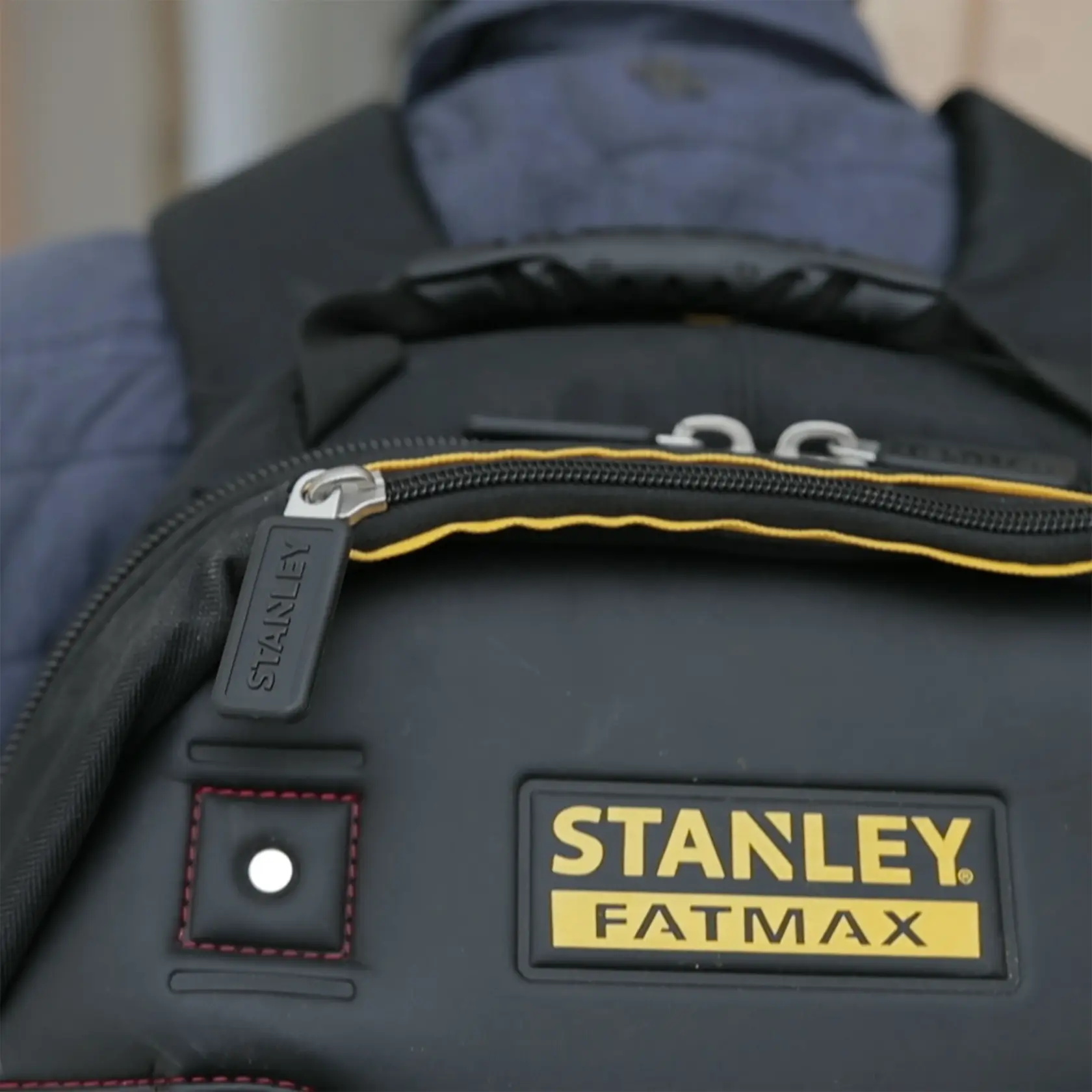 STANLEY 1-95-611 FATMAX black backpack, close-up showing logo and zipper detail.