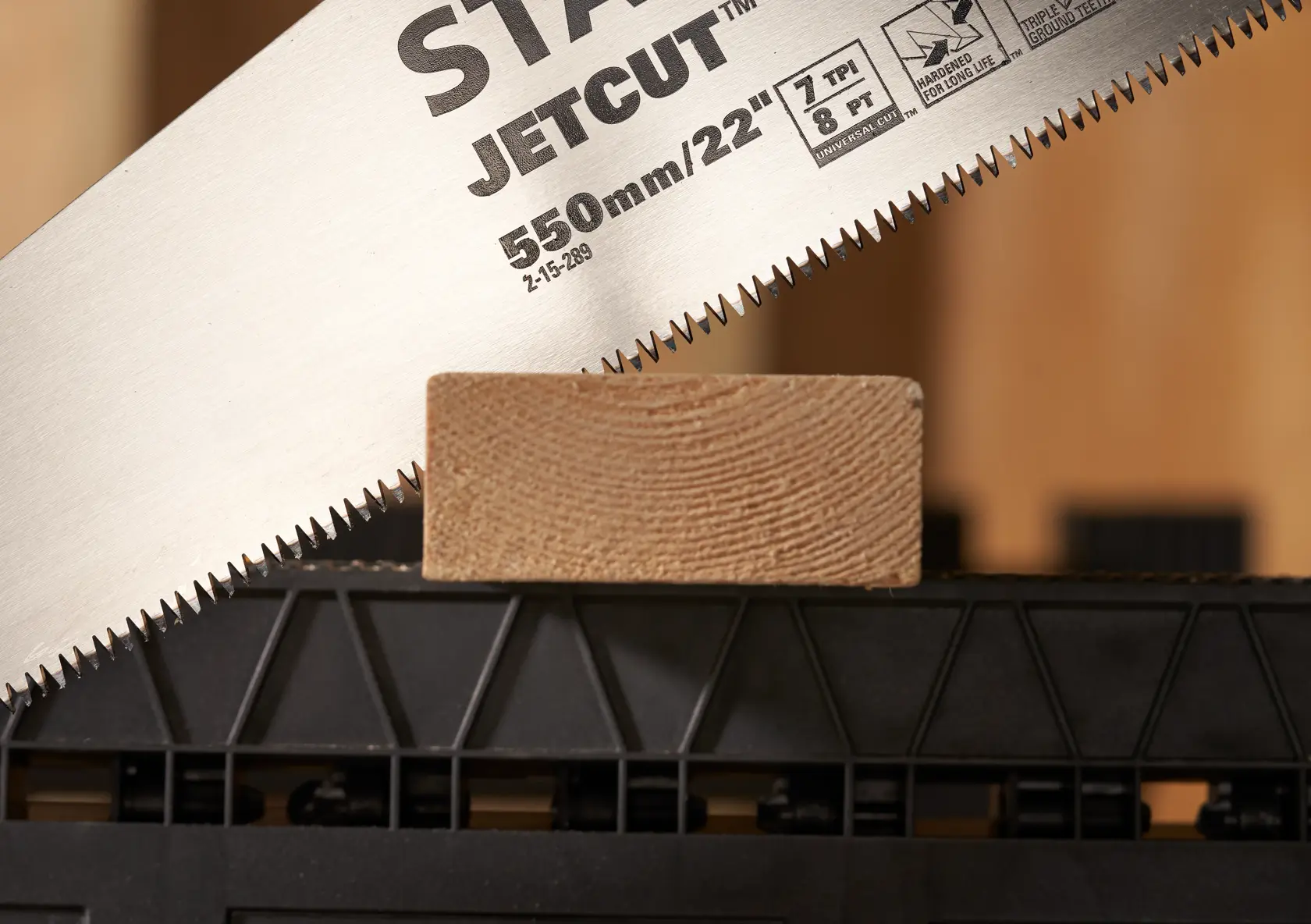 STANLEY 2-15-289 hand saw close-up cutting wood, photography, angled view on teeth and blade.