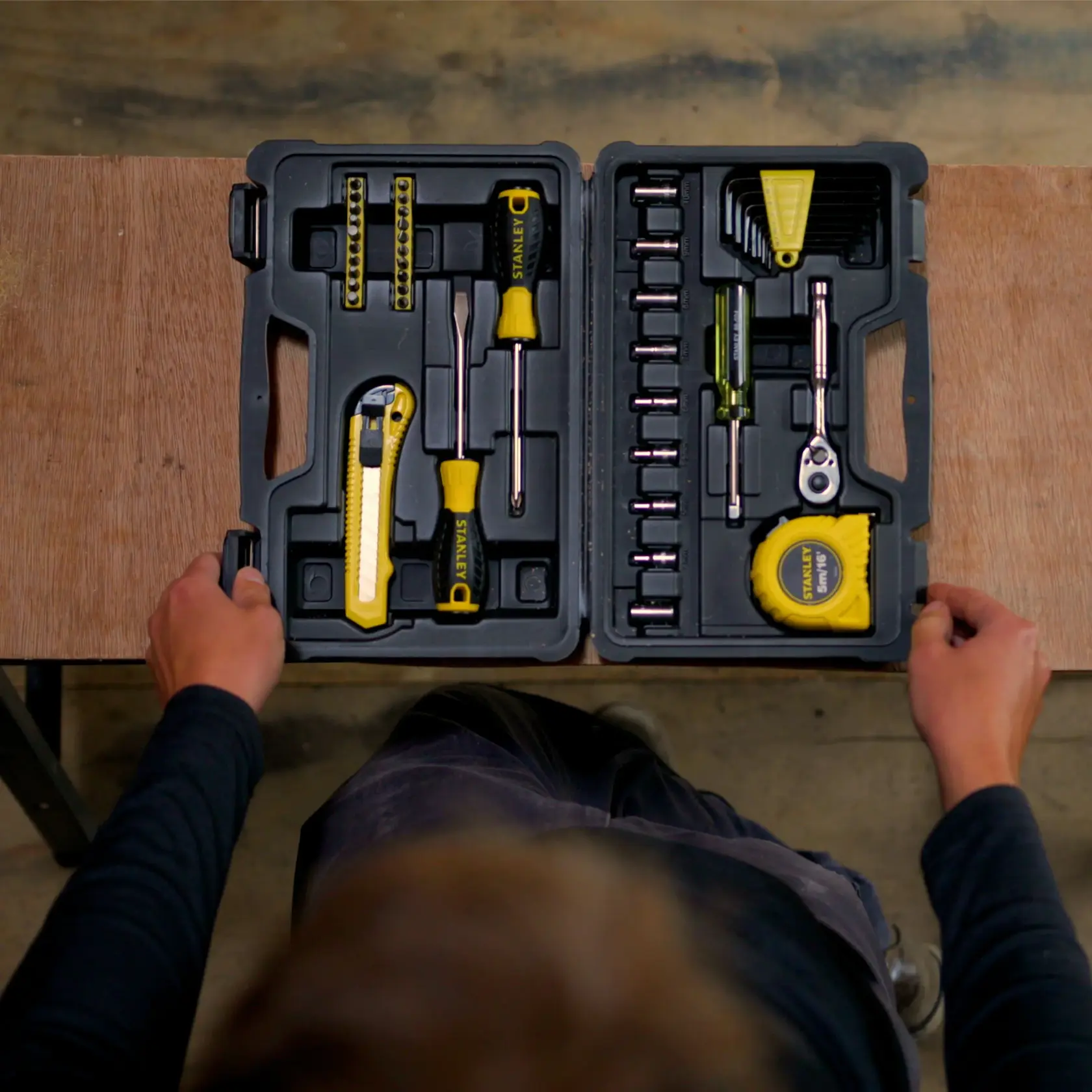 STANLEY STMT0-74864 tool kit photography, open case with assorted yellow and black hand tools, top view.