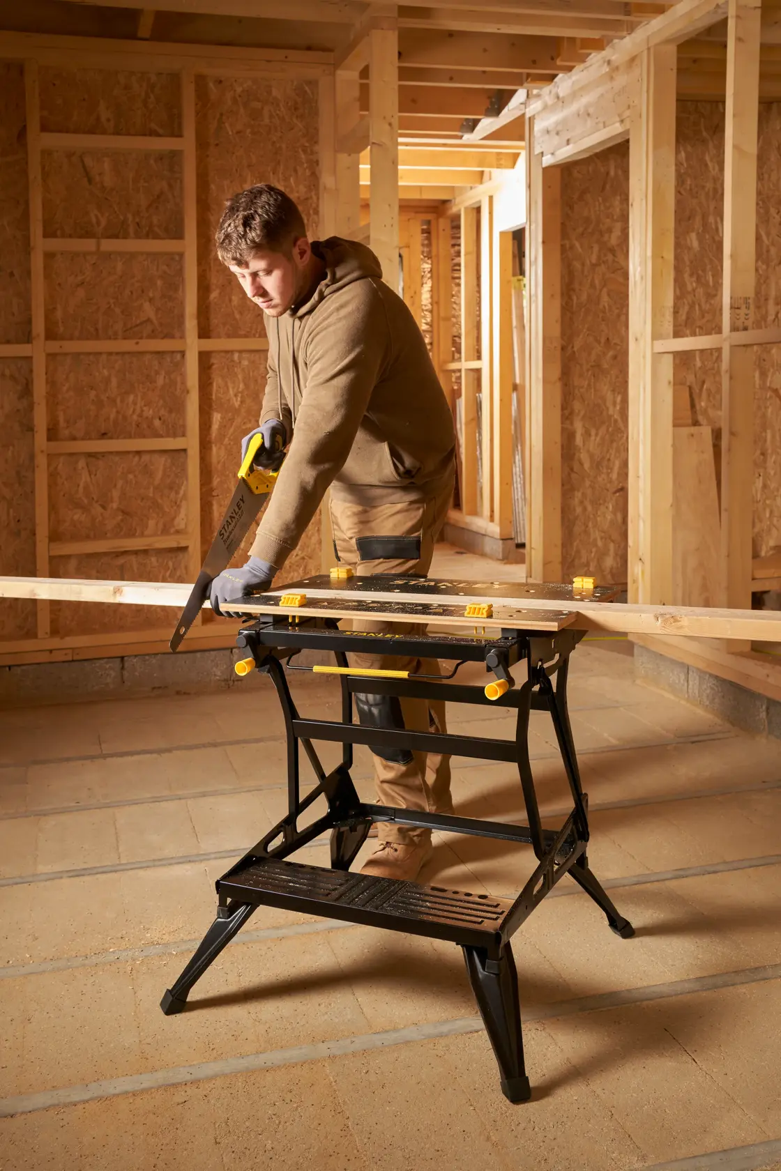 STANLEY STST83800-1 workbench in use at construction site, holding wood plank, photography product category.